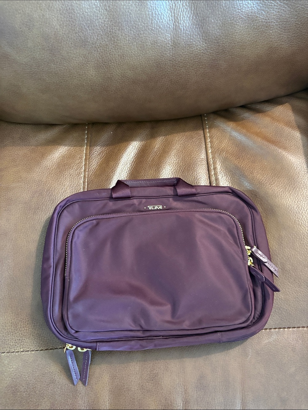 Tumi women’s or men’s Travel Toiletry Bag in Plum